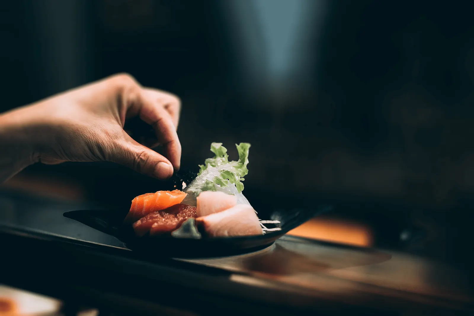A chef plating a dish in the Main Moon kitchen